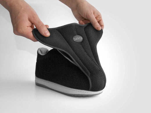 Black DARCO recovery shoe with breathable mesh, designed for foot rehabilitation and comfort.