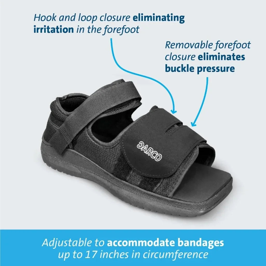 Black DARCO adjustable recovery sandal with hook and loop closure, designed for bandage accommodation and pressure relief.