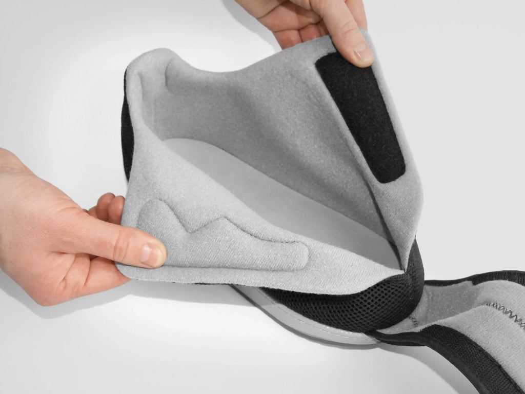 Grey and black adjustable back support brace with padded cushion for posture correction and recovery