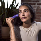 Therabody TheraFace Depuffing Wand in use on under-eye area