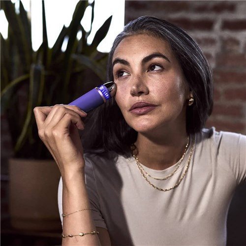 Therabody TheraFace Depuffing Wand in use on under-eye area