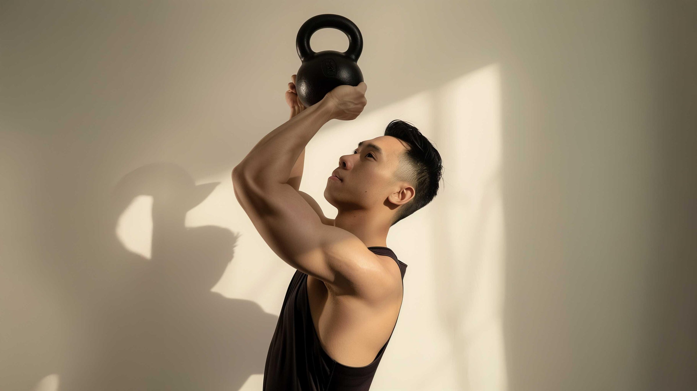 Man lifting black kettlebell for strength training and rehabilitation exercises