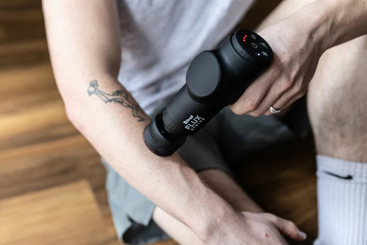 Strapit STRIVE massage gun in use